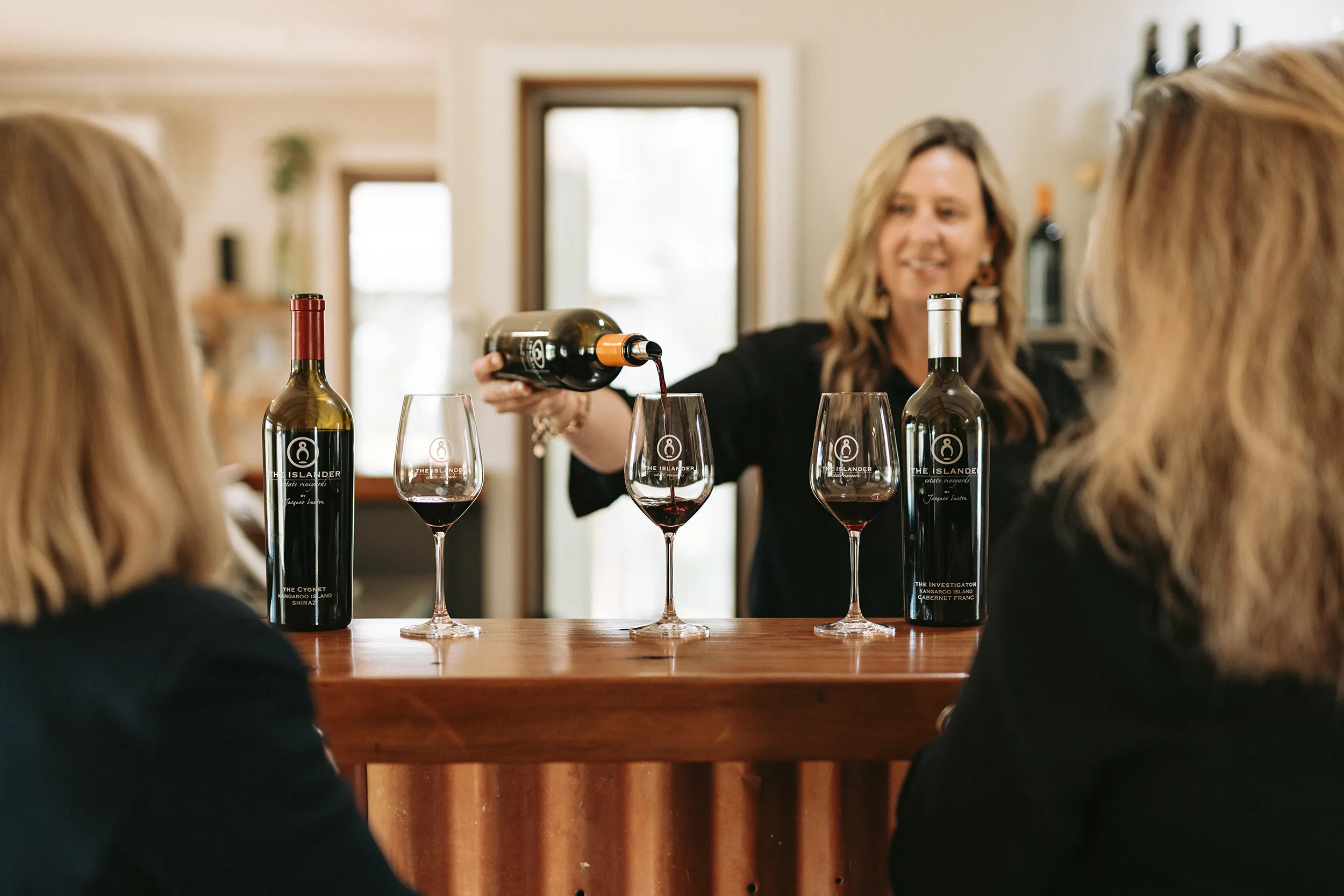 Person Pouring wine at The Islander Estate Vineyard
